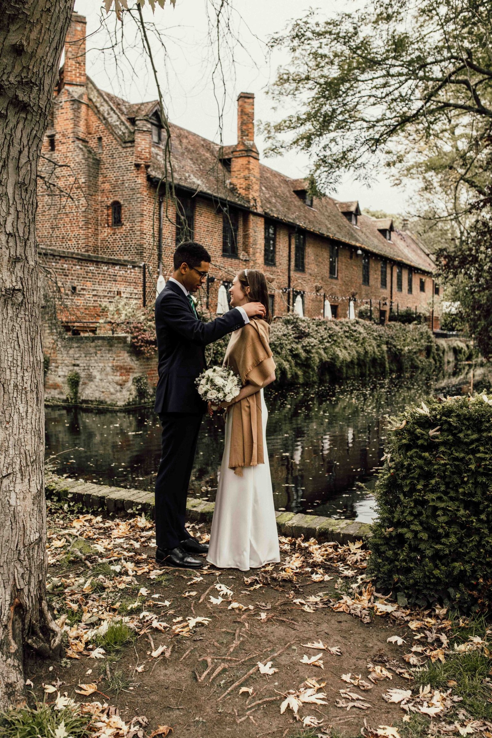 Katherine and Nathanaël beside the historic barn and moat