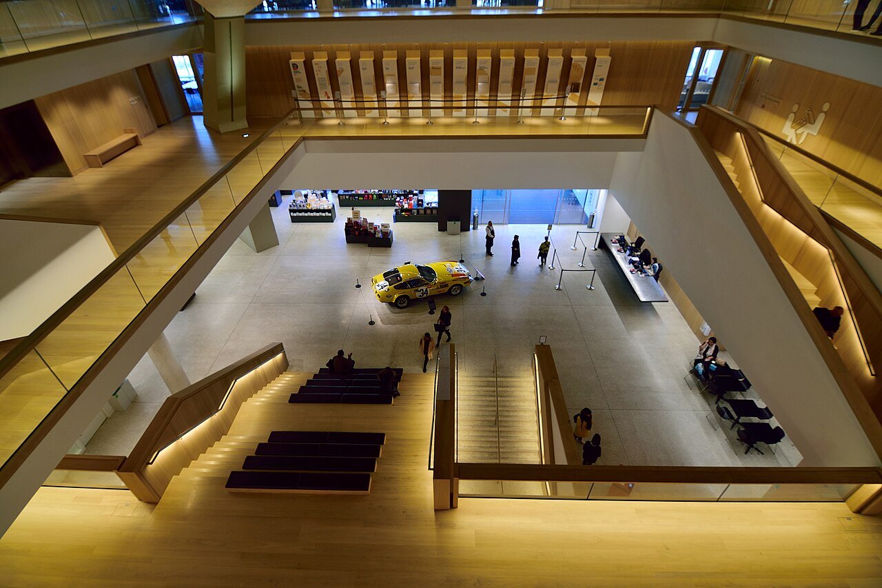 View into the Design Museum atrium in Kensington, with timber-lined galleries and a central staircase
