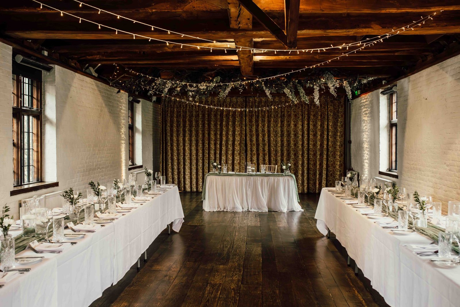 Wedding reception room beneath the wooden beams at Tudor Barn Eltham