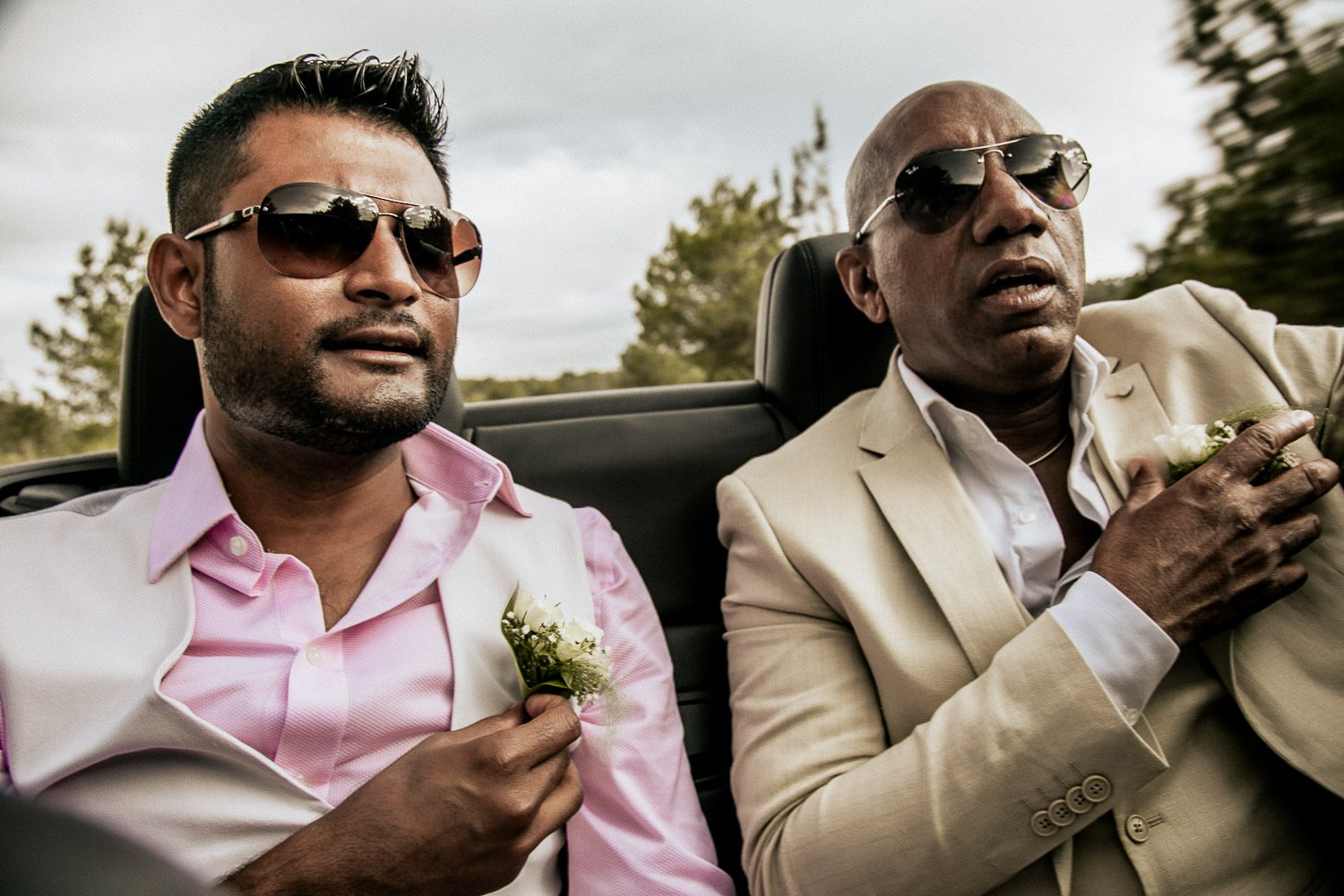 Mike and a friend enjoying the journey in an open-top wedding car