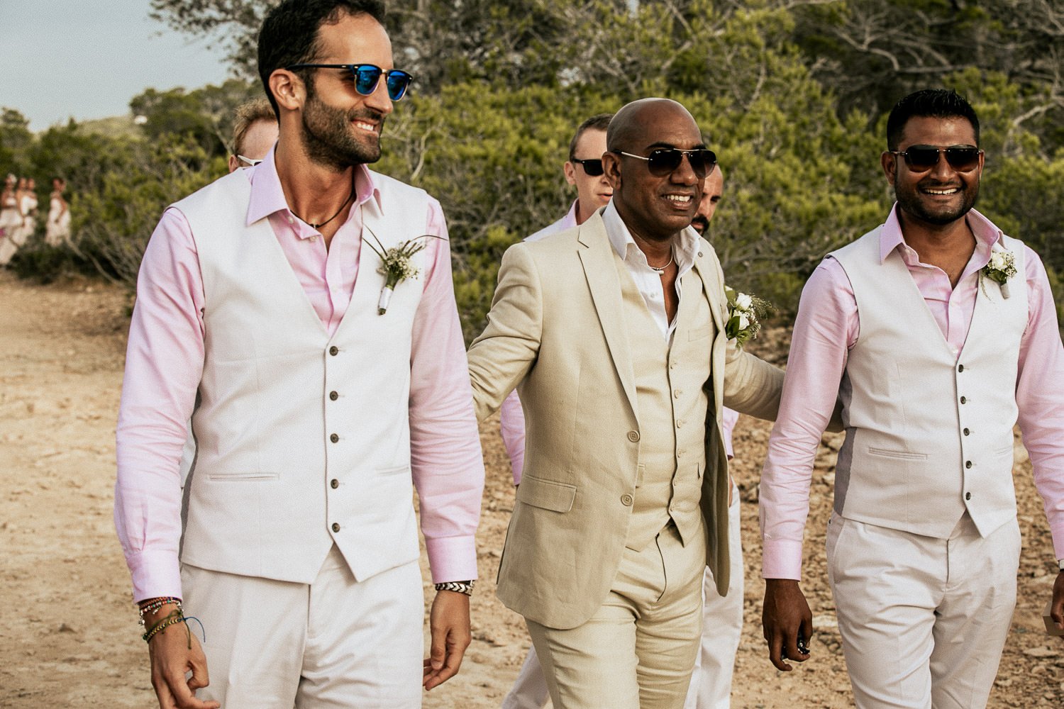 Mike in a cream suit with his wedding party