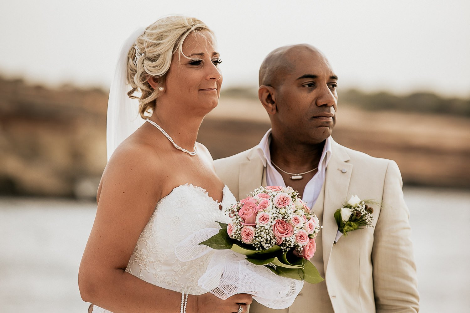 Mike and Monica together beside the sea at their wedding ceremony