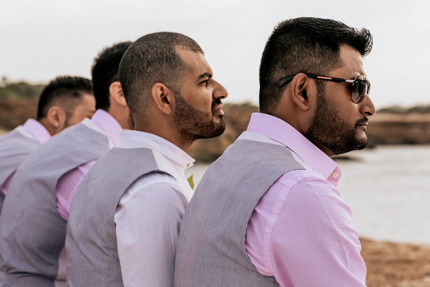Wedding guests watching the ceremony by the sea