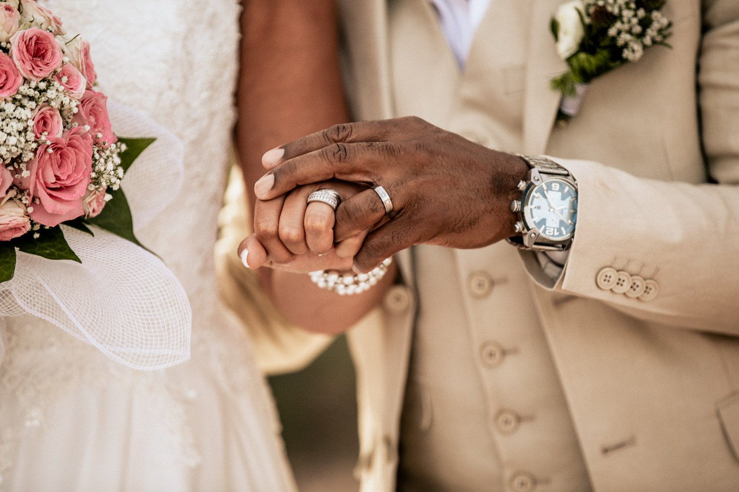 Wedding rings and pink flowers after the ceremony
