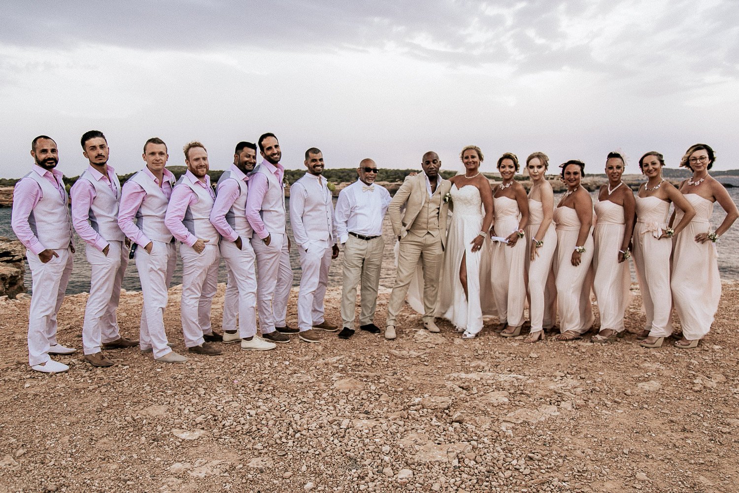Mike and Monica with their wedding party beside the sea