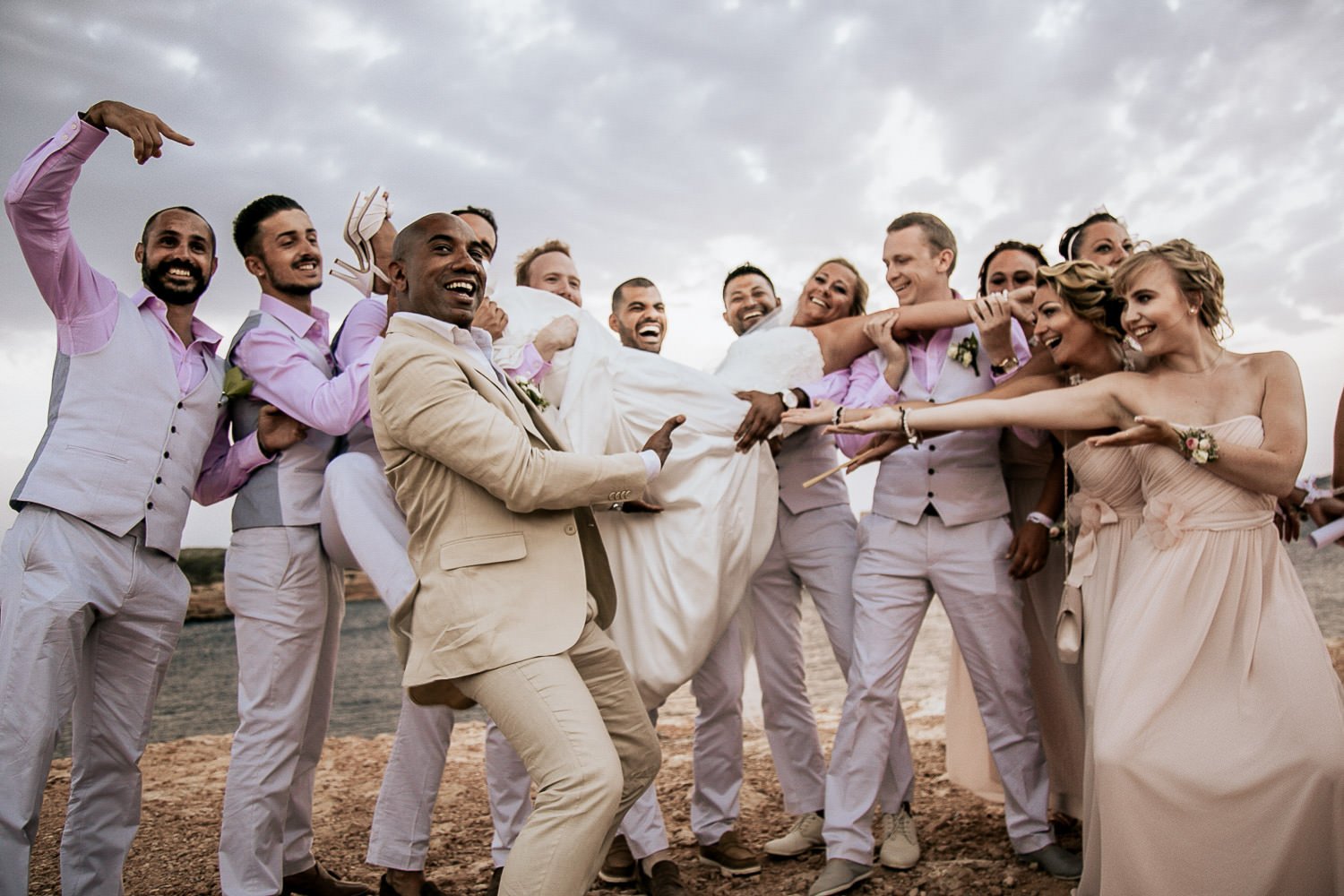 The wedding party laughing and celebrating together in Ibiza